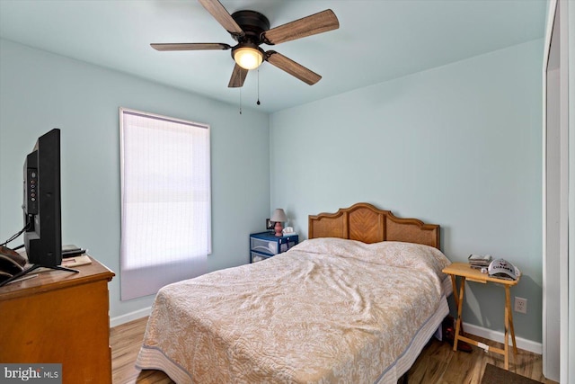 bedroom featuring hardwood / wood-style flooring and ceiling fan