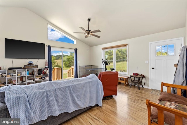 bedroom with ceiling fan, access to outside, multiple windows, and light wood-type flooring