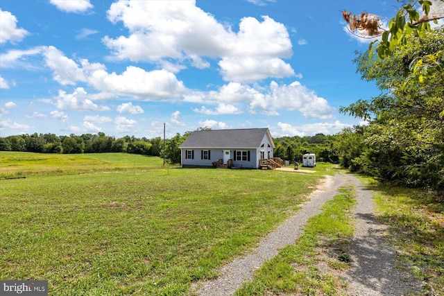 view of front facade with a front yard and a rural view