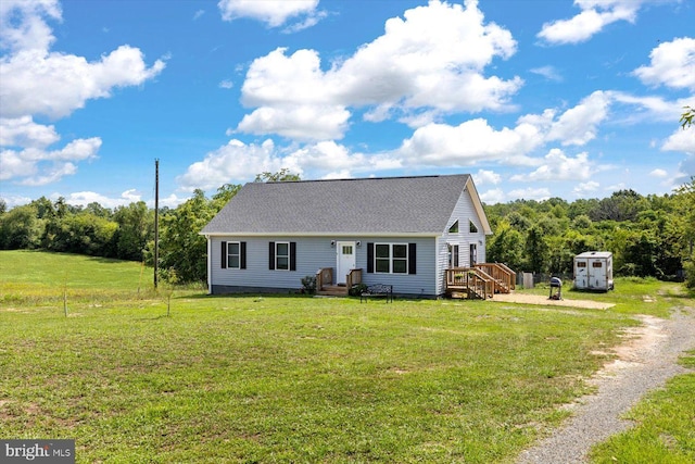 view of front of home featuring a front yard and a storage unit