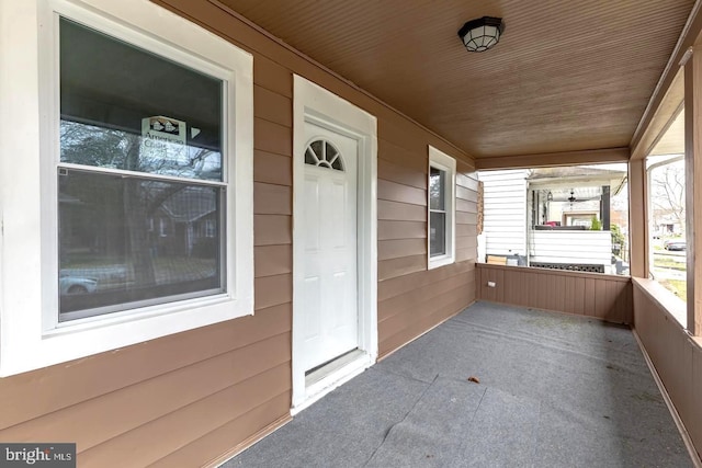 unfurnished sunroom with wooden ceiling