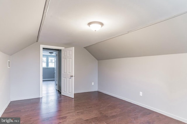 bonus room with vaulted ceiling and dark hardwood / wood-style floors