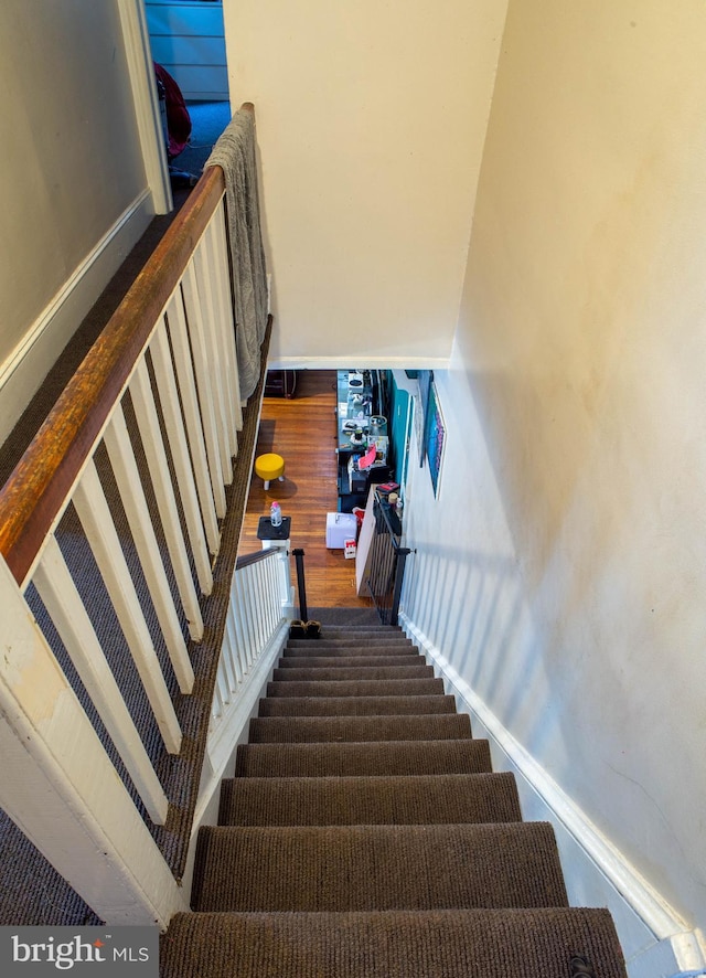 staircase with hardwood / wood-style flooring