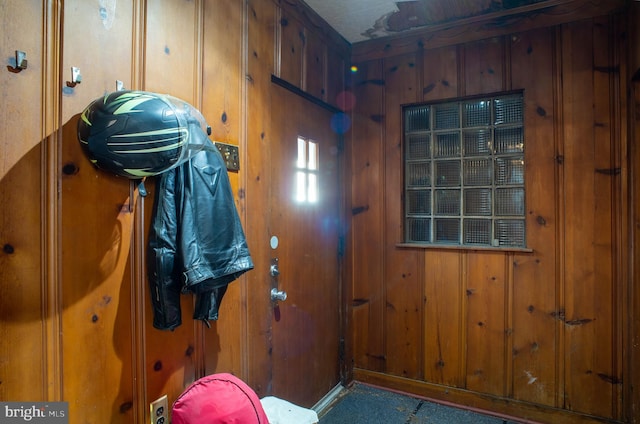 entryway with wooden walls