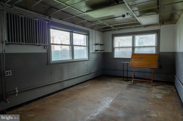 unfurnished room with concrete flooring