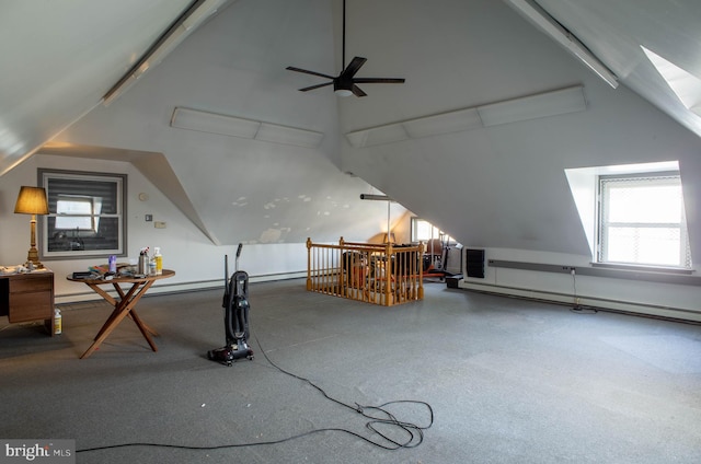 additional living space with ceiling fan, a skylight, and a baseboard heating unit