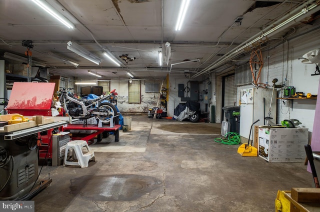 garage featuring a workshop area and electric panel