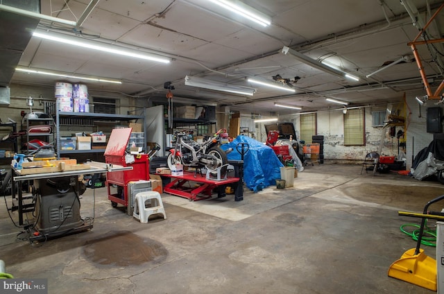 garage with electric panel and a workshop area