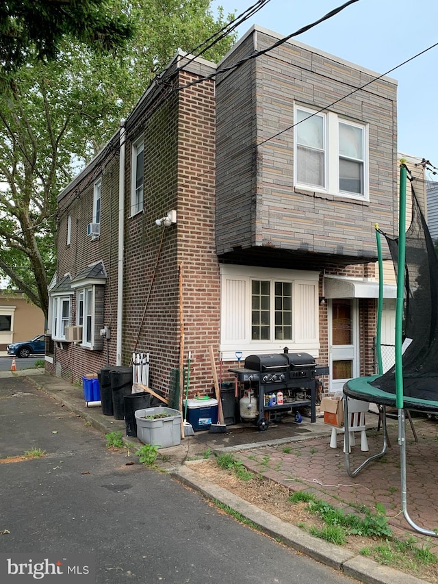 townhome / multi-family property featuring a trampoline and cooling unit