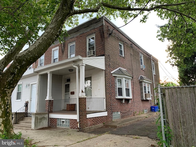 view of front of property featuring covered porch and cooling unit