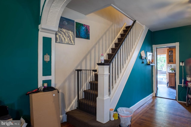 stairs featuring dark hardwood / wood-style flooring