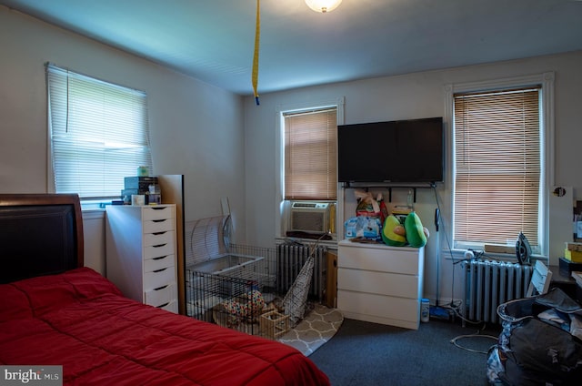 carpeted bedroom featuring cooling unit and radiator heating unit