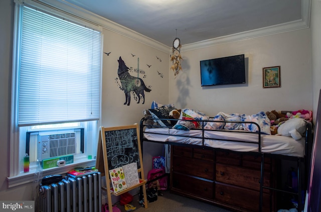 carpeted bedroom featuring cooling unit, radiator, and crown molding