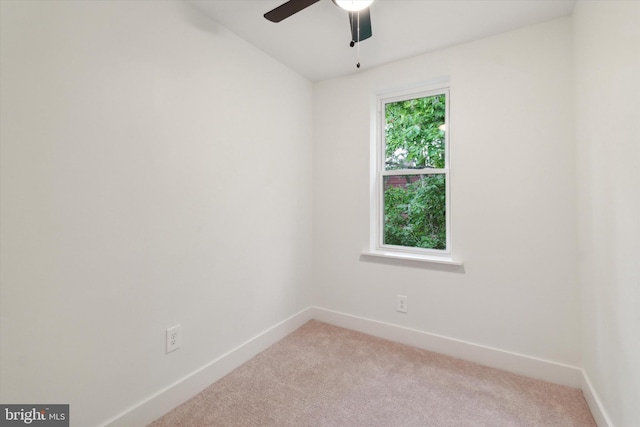 carpeted spare room with ceiling fan