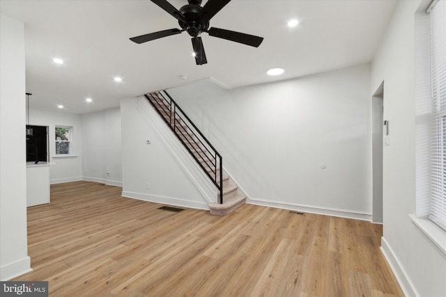 unfurnished living room featuring ceiling fan and light hardwood / wood-style flooring