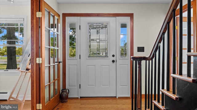 foyer featuring a baseboard radiator and light hardwood / wood-style floors