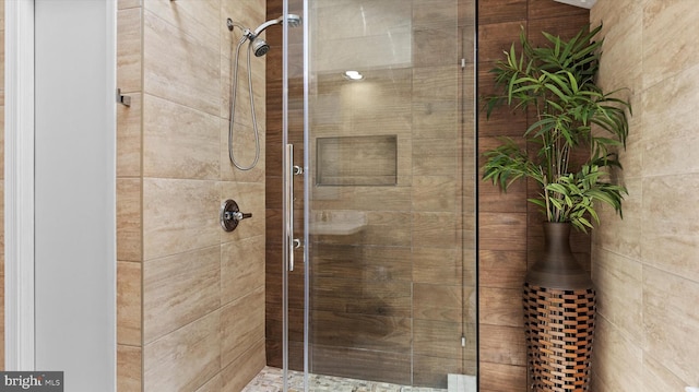 bathroom featuring a shower with door