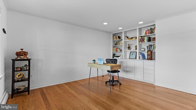 office featuring built in shelves, a baseboard radiator, crown molding, and light hardwood / wood-style flooring