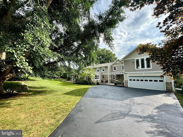 view of front of home with a garage and a front yard