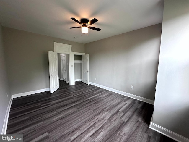 unfurnished bedroom with dark hardwood / wood-style floors and ceiling fan