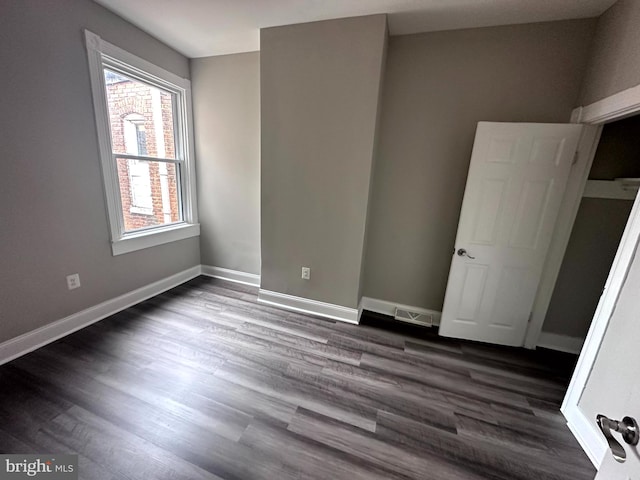 unfurnished bedroom featuring dark wood-type flooring