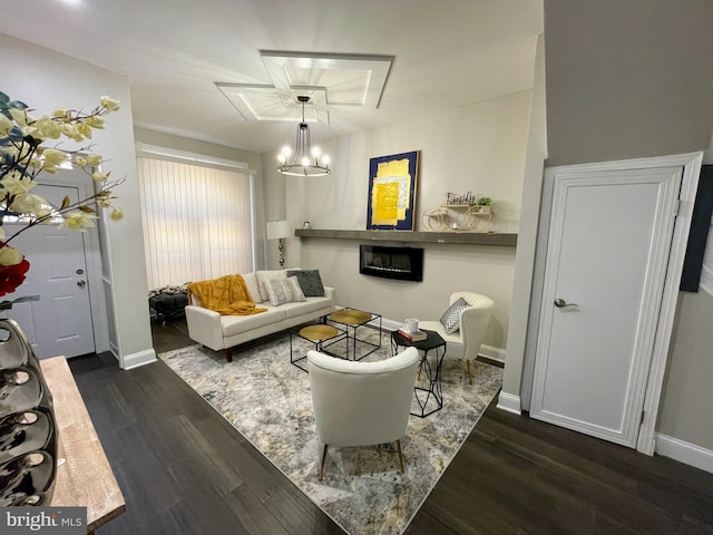 living room with an inviting chandelier and dark hardwood / wood-style floors