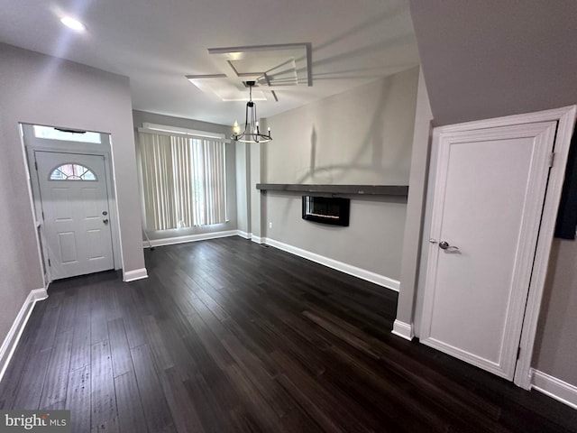 entrance foyer featuring an inviting chandelier and dark hardwood / wood-style floors