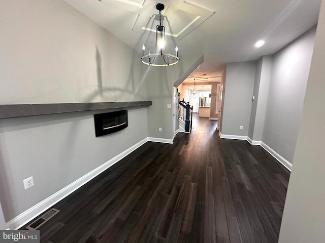 unfurnished dining area with an inviting chandelier and dark hardwood / wood-style floors