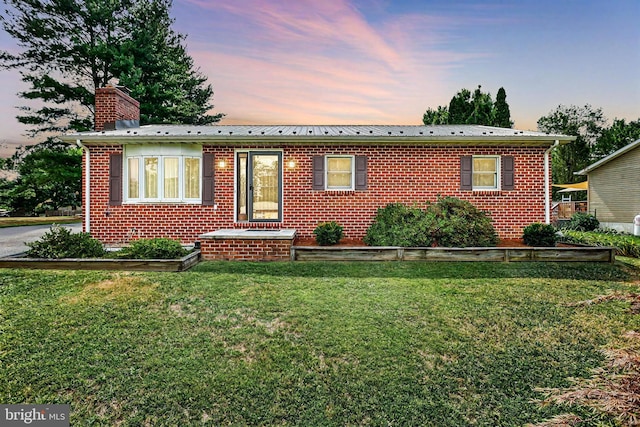 view of front of house with a yard