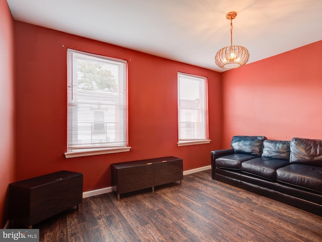 living room featuring a chandelier and dark hardwood / wood-style floors