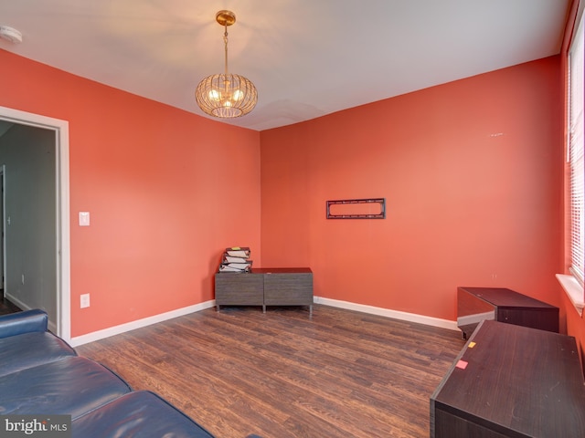 living area with a chandelier and dark hardwood / wood-style floors