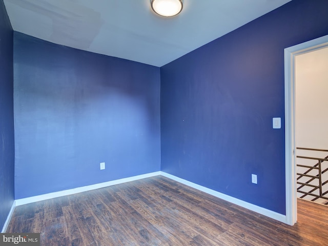 empty room featuring dark hardwood / wood-style flooring