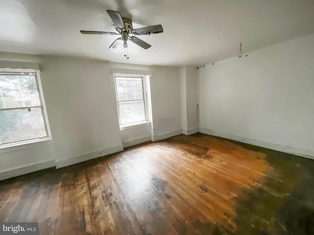 unfurnished room featuring ceiling fan and dark hardwood / wood-style flooring