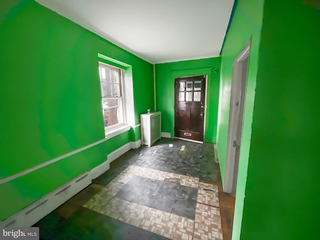 doorway featuring a baseboard heating unit