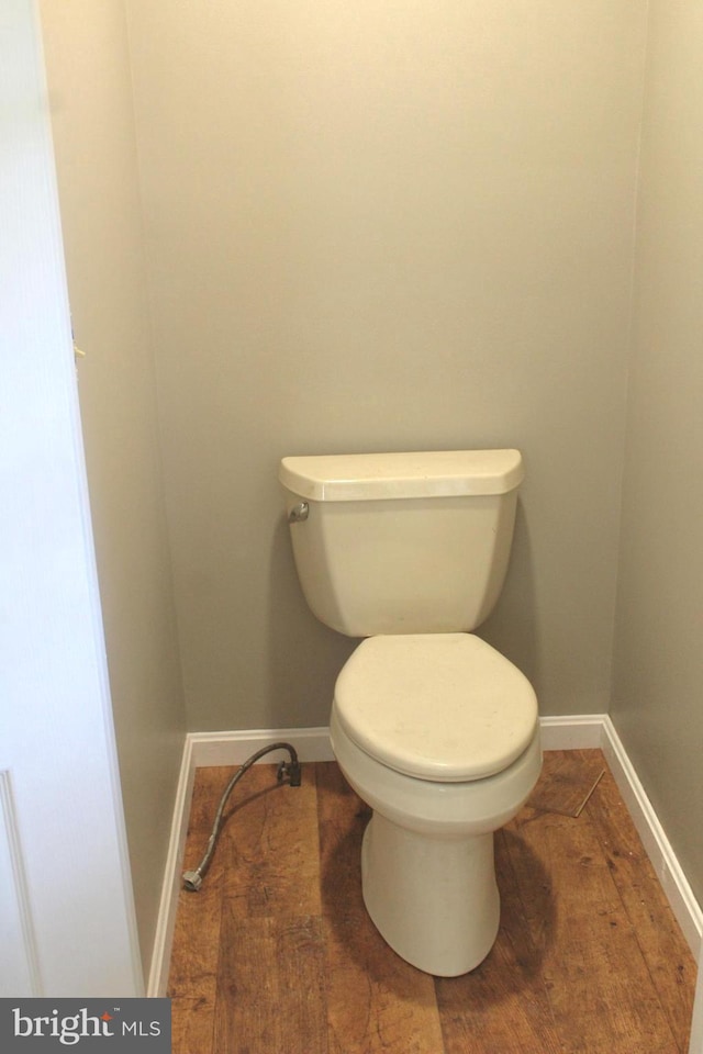 bathroom featuring wood-type flooring and toilet