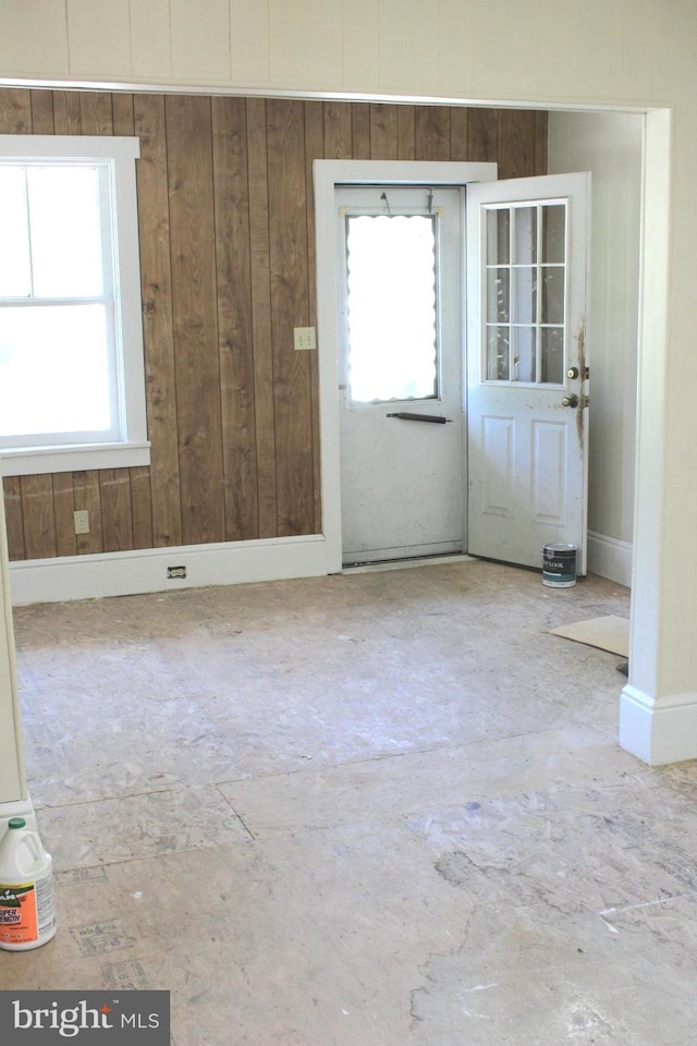 foyer entrance with wood walls