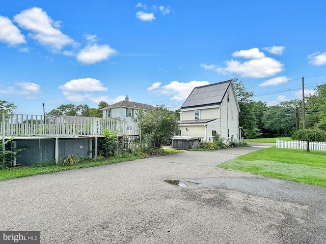 view of side of home with a lawn