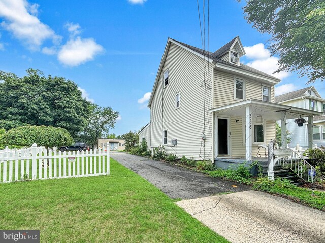 exterior space with a porch and a front lawn