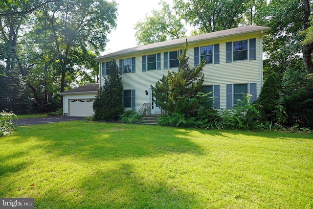 colonial house with a garage and a front yard