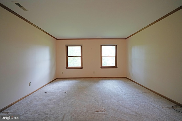 spare room with light colored carpet and ornamental molding