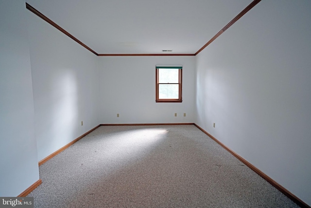 carpeted spare room with ornamental molding