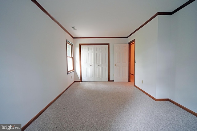 unfurnished bedroom featuring carpet flooring and ornamental molding