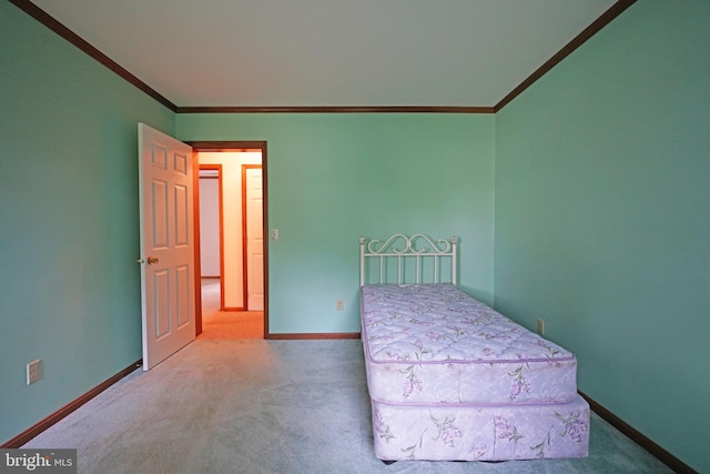 unfurnished bedroom featuring carpet floors and crown molding