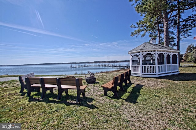 surrounding community with a gazebo, a yard, and a water view