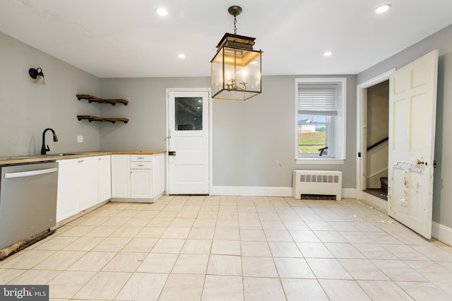 kitchen featuring radiator, decorative light fixtures, dishwasher, sink, and white cabinets