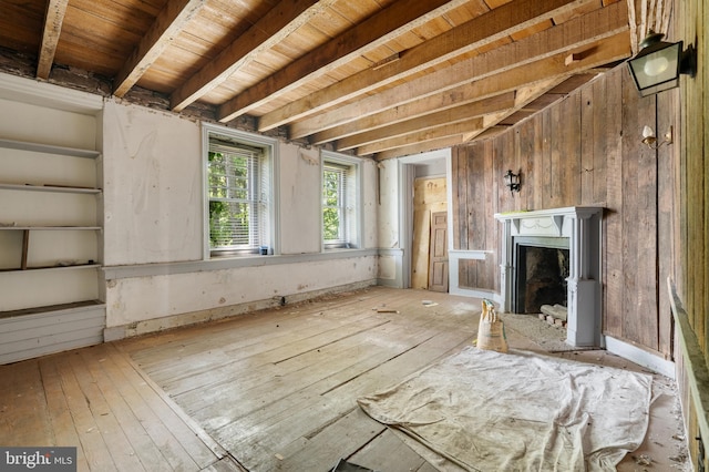 miscellaneous room with beam ceiling, wood-type flooring, wooden ceiling, and a premium fireplace