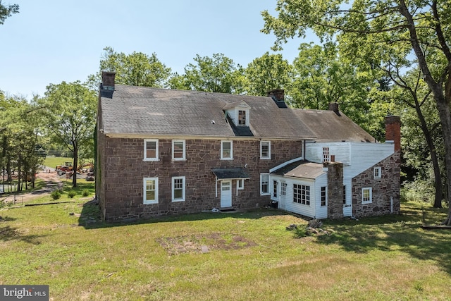 back of house featuring a lawn