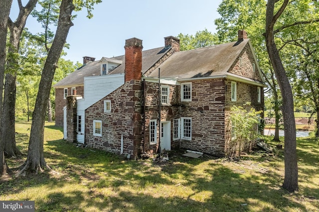 rear view of house with a lawn