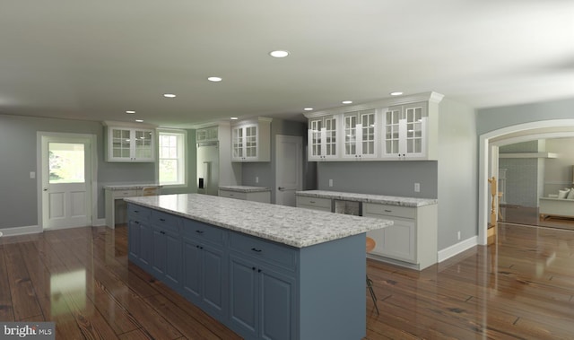 kitchen featuring a kitchen island, dark hardwood / wood-style floors, blue cabinets, white cabinetry, and built in refrigerator