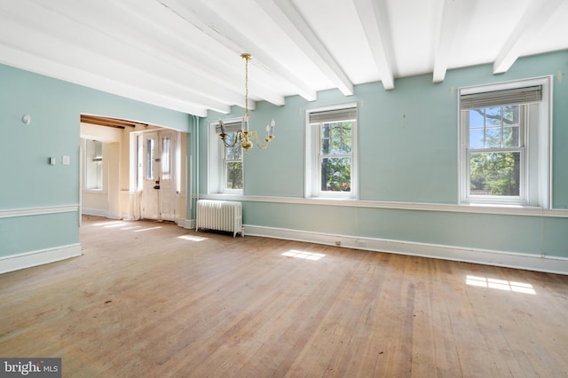 unfurnished dining area with an inviting chandelier, radiator, light hardwood / wood-style floors, and beamed ceiling